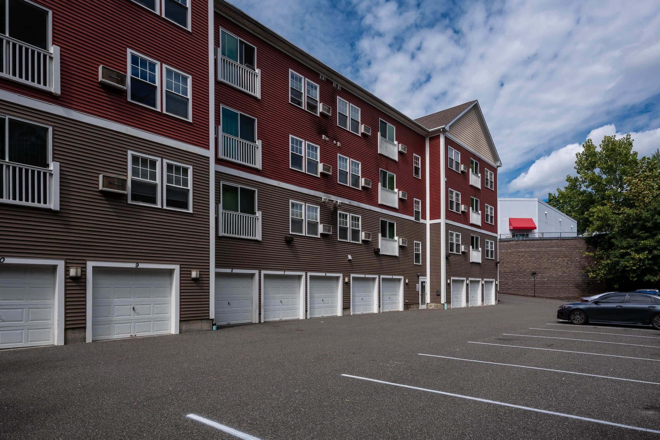 The row of numbered private garages along the side of the Barton Commons building